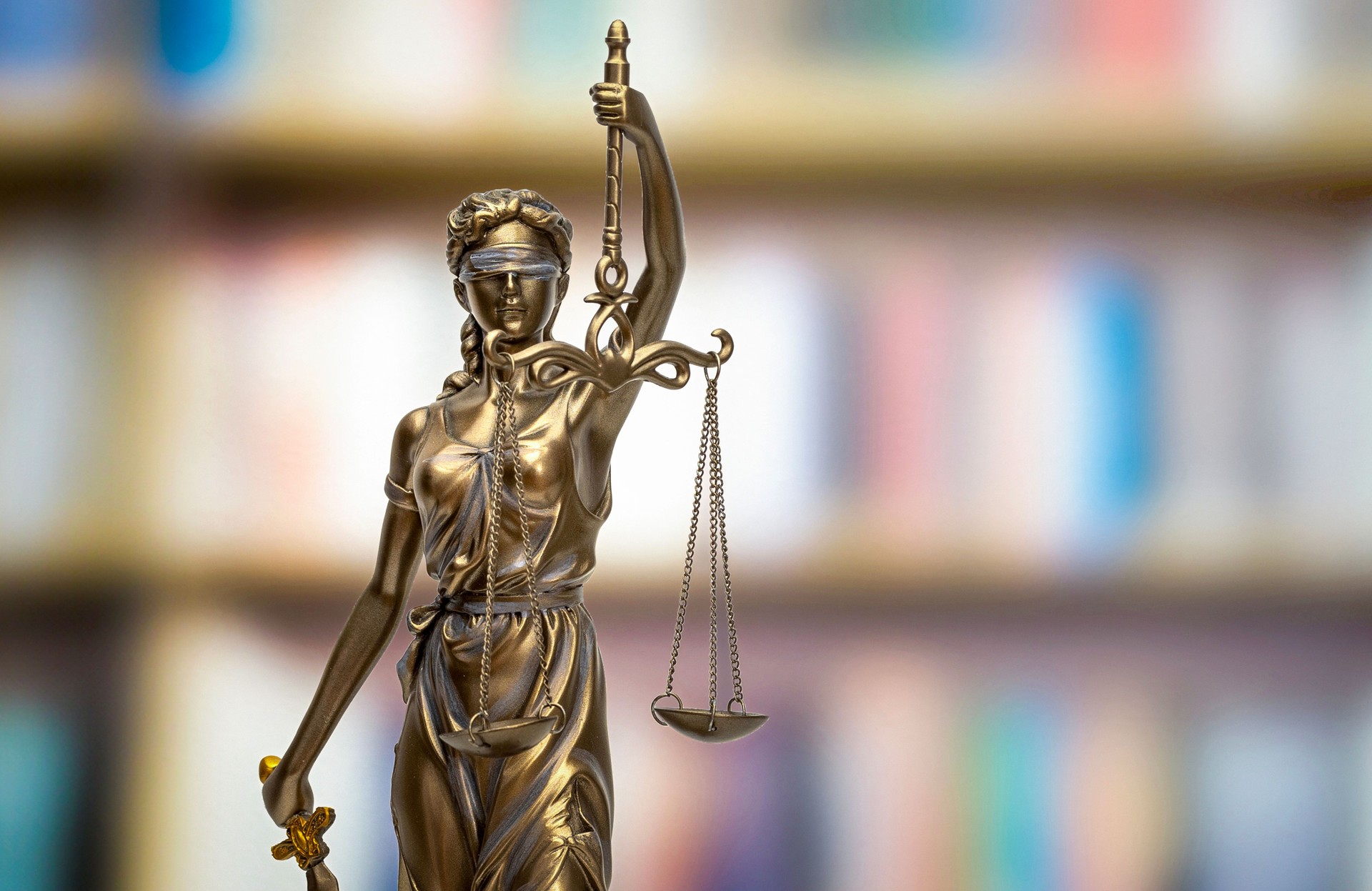 THEMIS in front of blurred bookshelf background